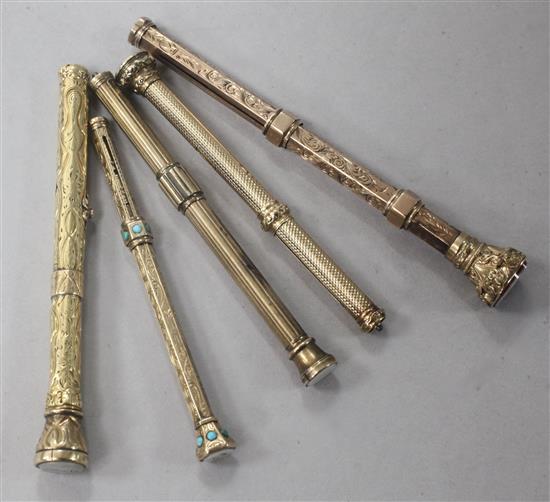 Five early 20th century yellow metal overlaid and chalcedony set propelling pencils, one set with turquoise stones.